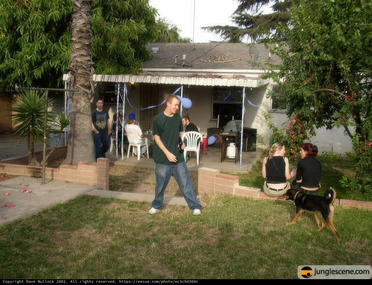 Man and Dog Enjoying their Villa Backyard