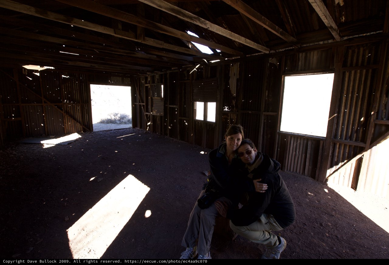 Couple Poses Inside Abandoned Desert Ghost Town Structure