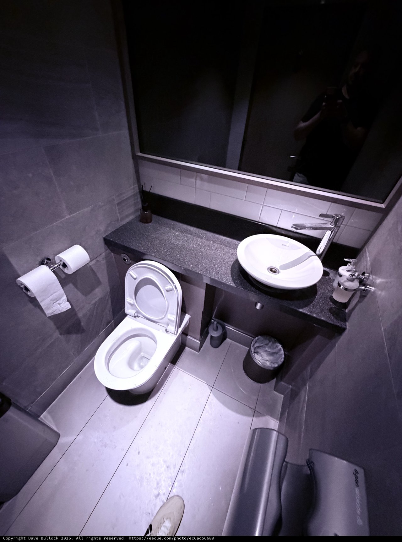 Modern Minimalist Bathroom with Dark Granite Countertops