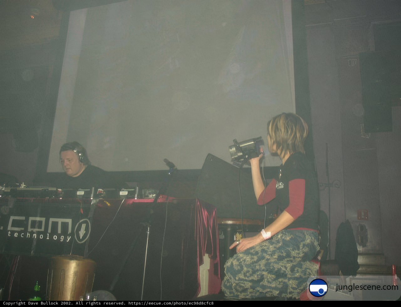 Woman enjoys musical performance by the DJ on stage