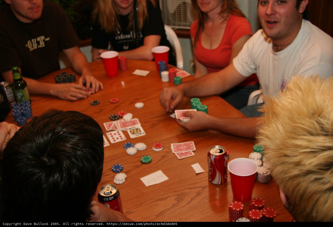 Friends Gathered Around Table for Poker Night