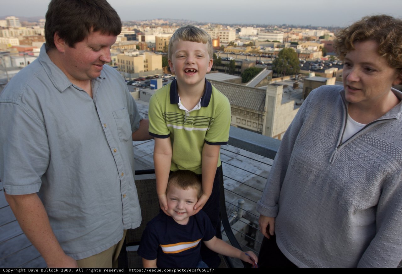 Family Rooftop Gathering at Dusk Over the City