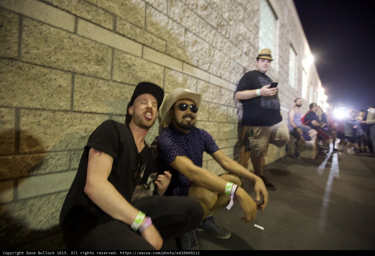 FYF Fest Two Men Sitting Wall Black Cap Cowboy Hat Sunglasses Beard Wristbands Night