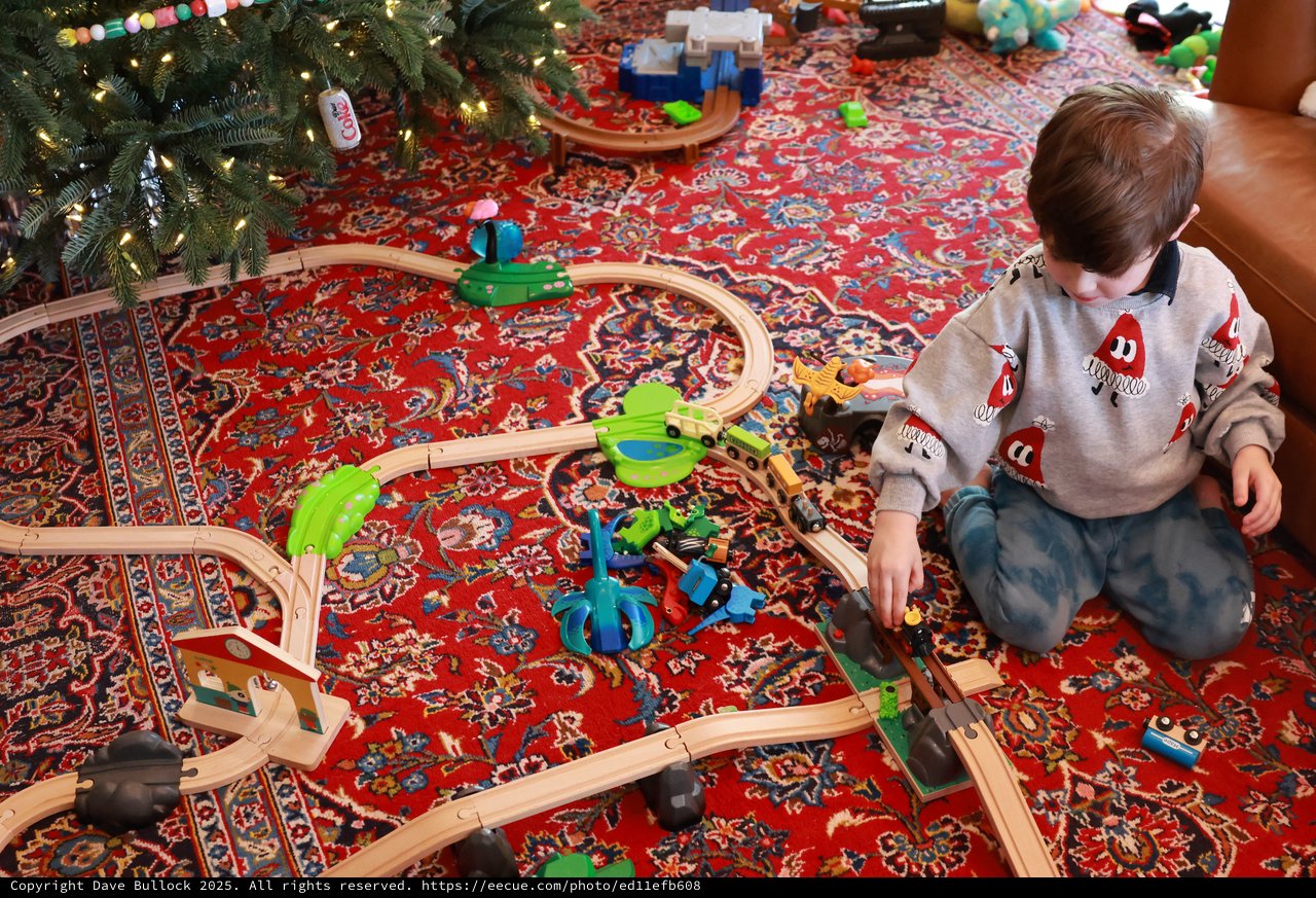 Child Playing with Wooden Train Set on Christmas