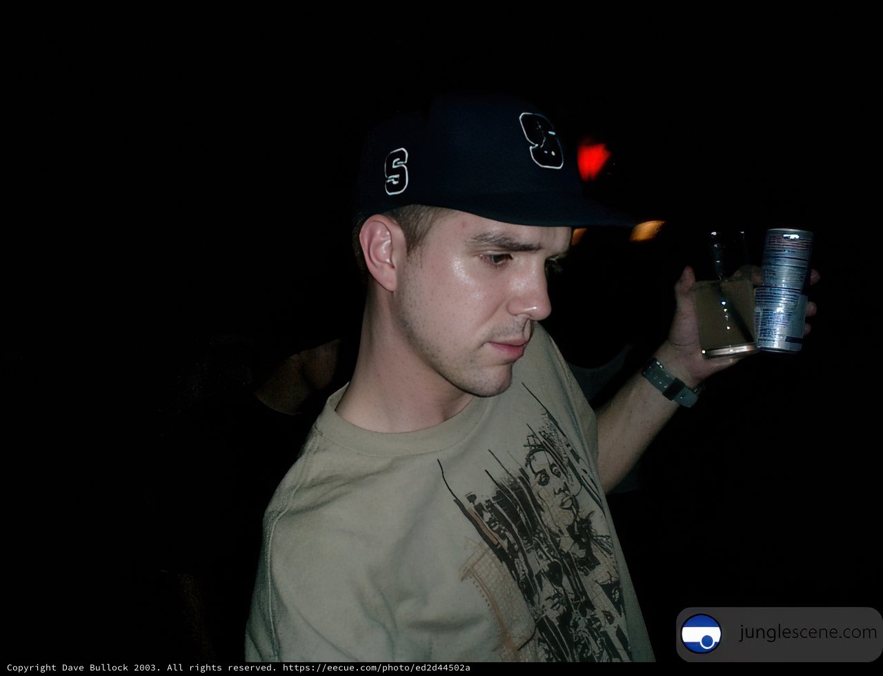Lenny R enjoying a cold one Caption: Lenny R rocks his baseball cap and bracelet while savoring a refreshing beverage on a sunny day in 2003.