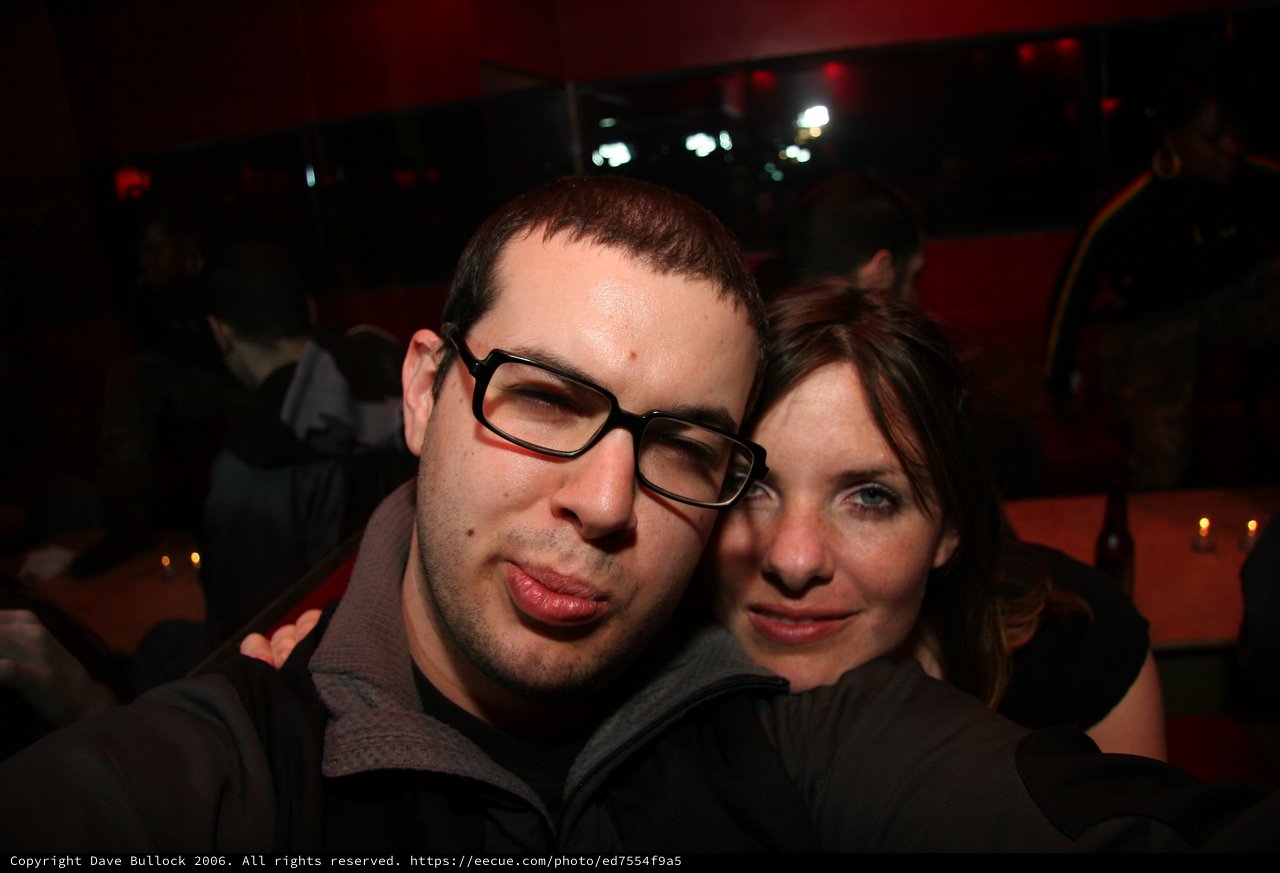 Friends Posing Together at a Dimly Lit Nightclub