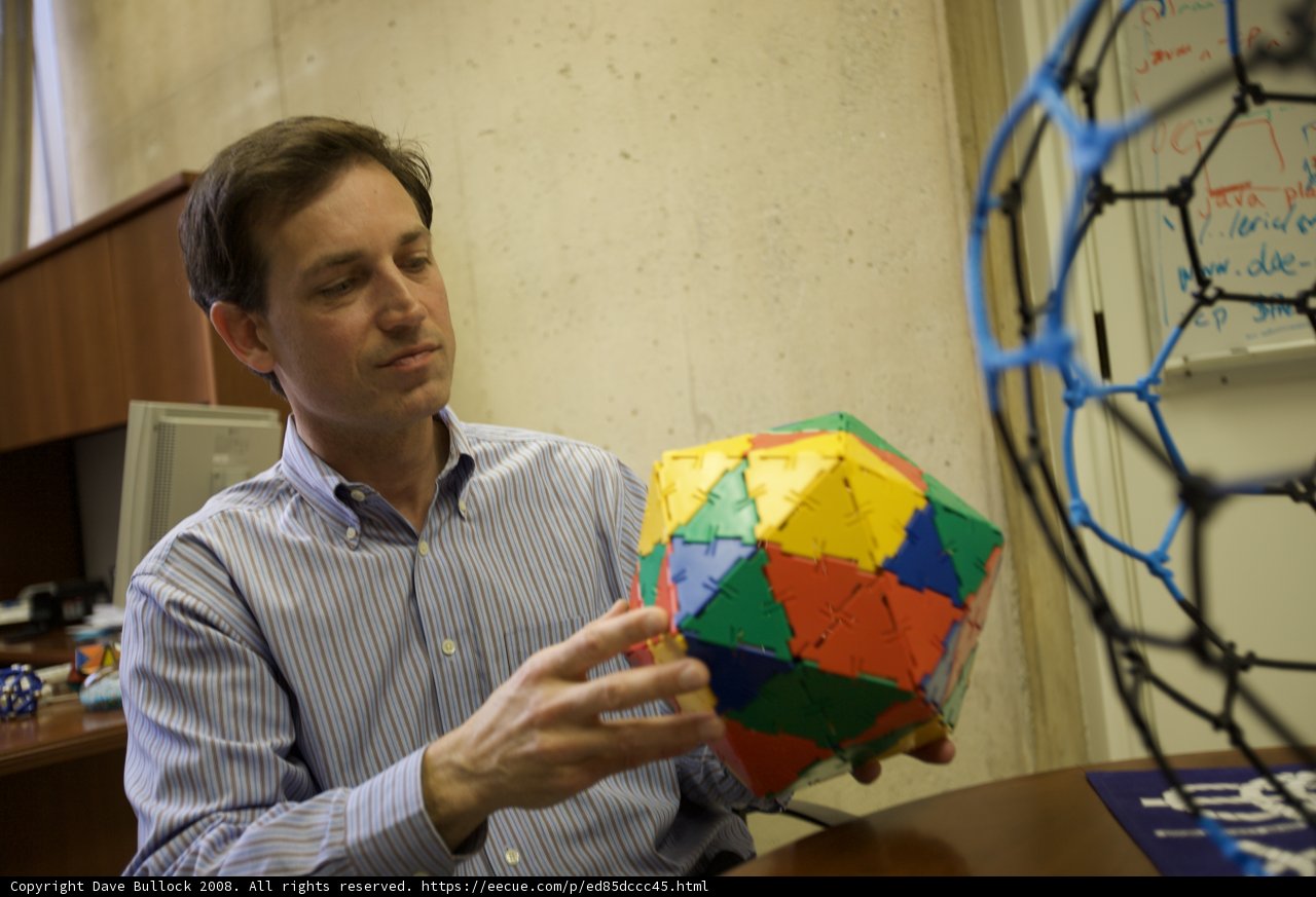 Man Holding a Colorful Sphere