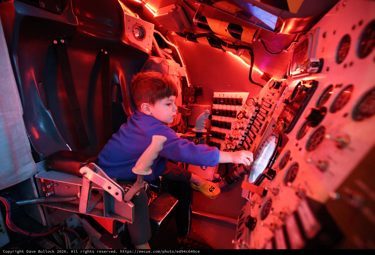 Young Explorer in Submarine Control Room Simulation