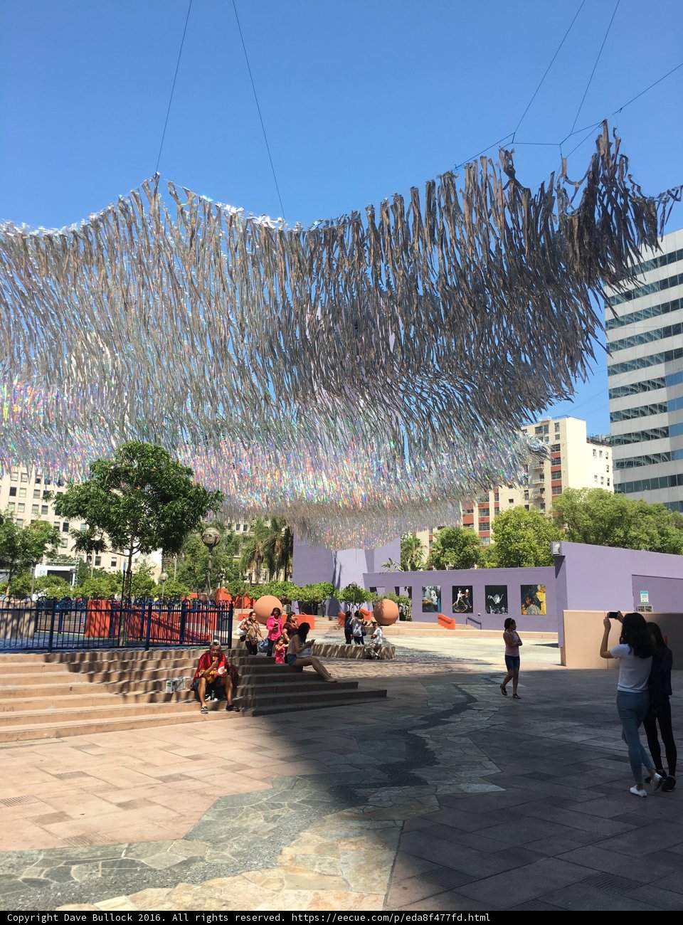 Hanging Paper Sculpture Overlooks Vibrant City Plaza