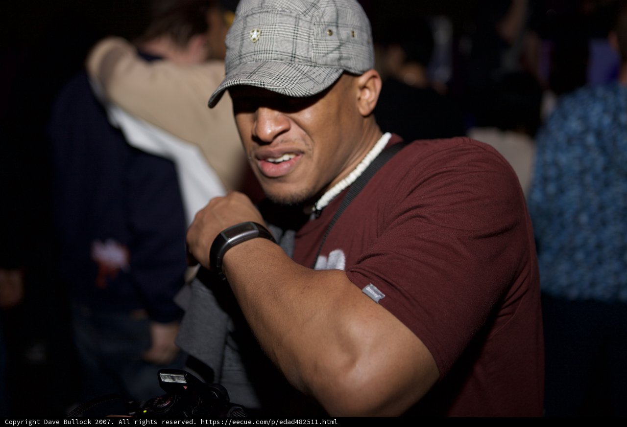 Grey Shirted Man with Baseball Cap and Timepiece