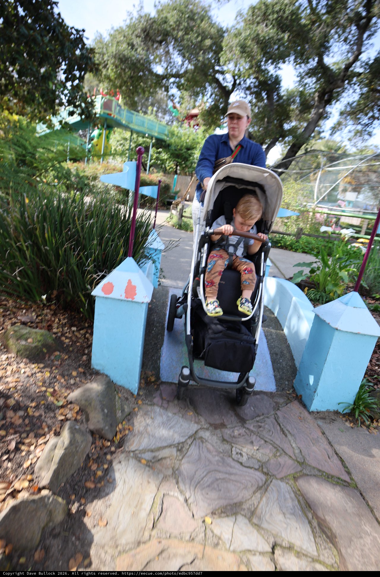 Parent and Child Crossing Miniature Bridge at Fantasyland
