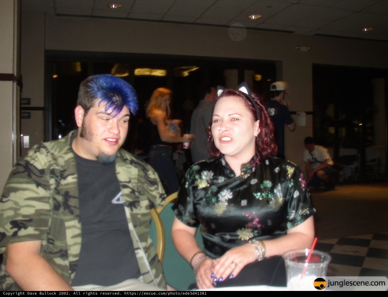 Blue-haired couple enjoying a night out at a military-themed bar