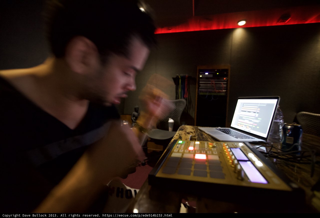 Grooving with the Beat: Man on Drum Machine in Studio