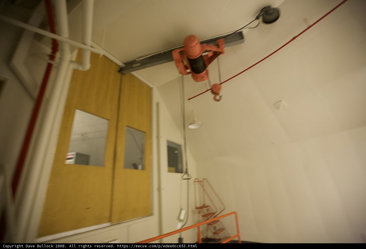 Suspended Red Crane in an Indoor Setting