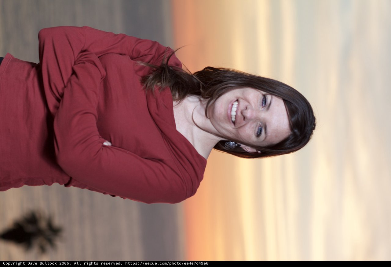 Woman Smiling at Sunset by the Ocean