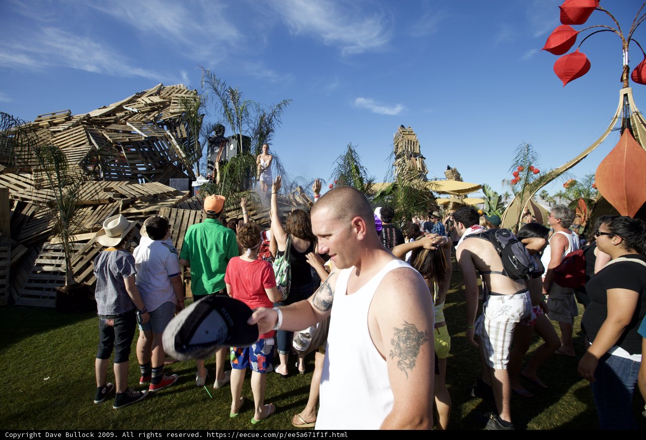 Man with a Hat and a Backpack Facing the Crowd