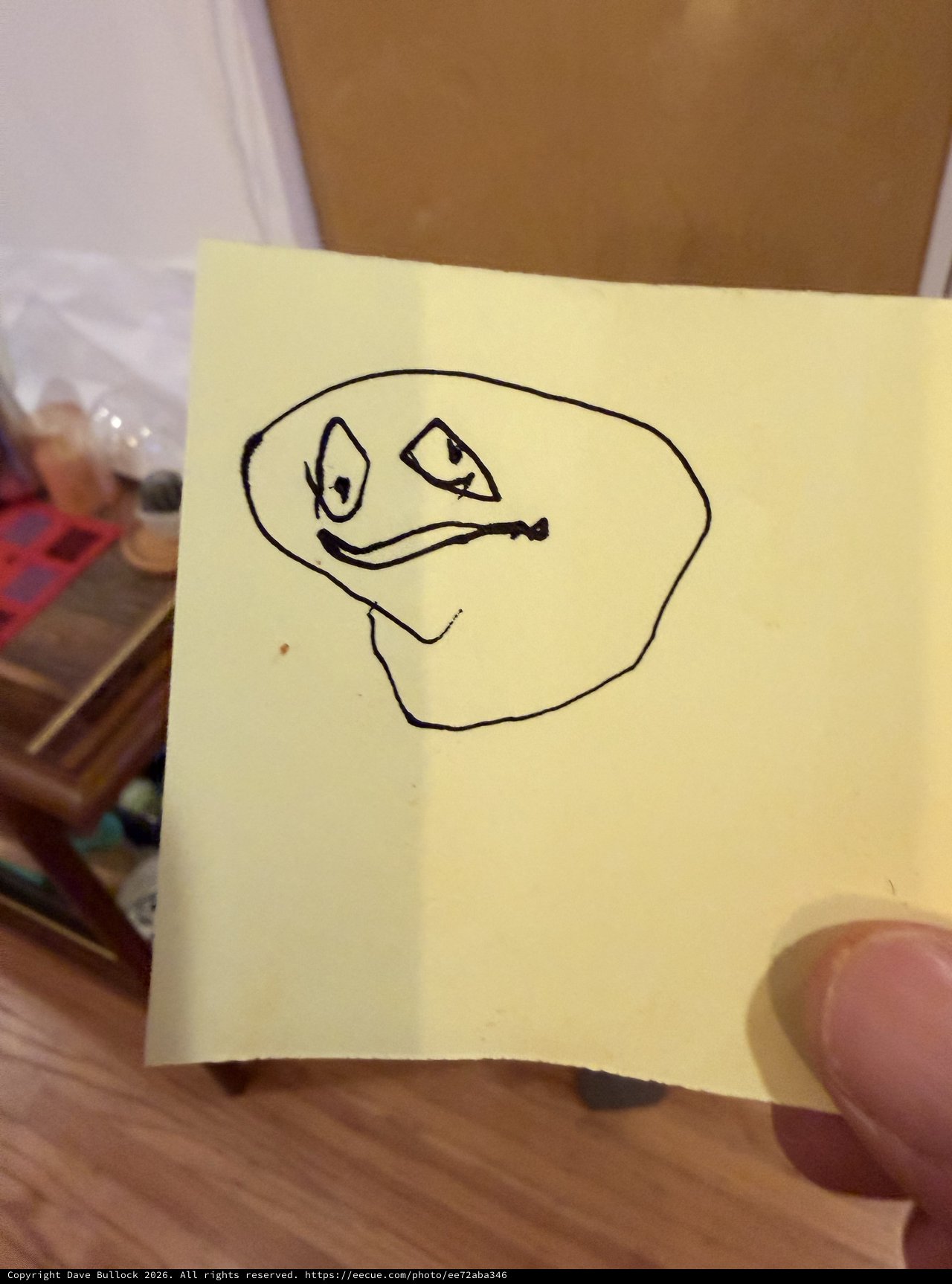 Hand-Drawn Meme Face on Yellow Sticky Note
