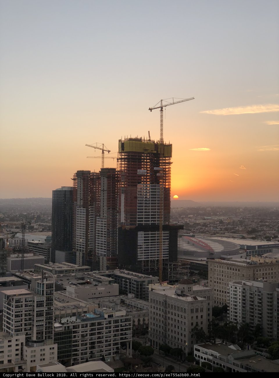 Urban Sunset over High-Rise Construction Site