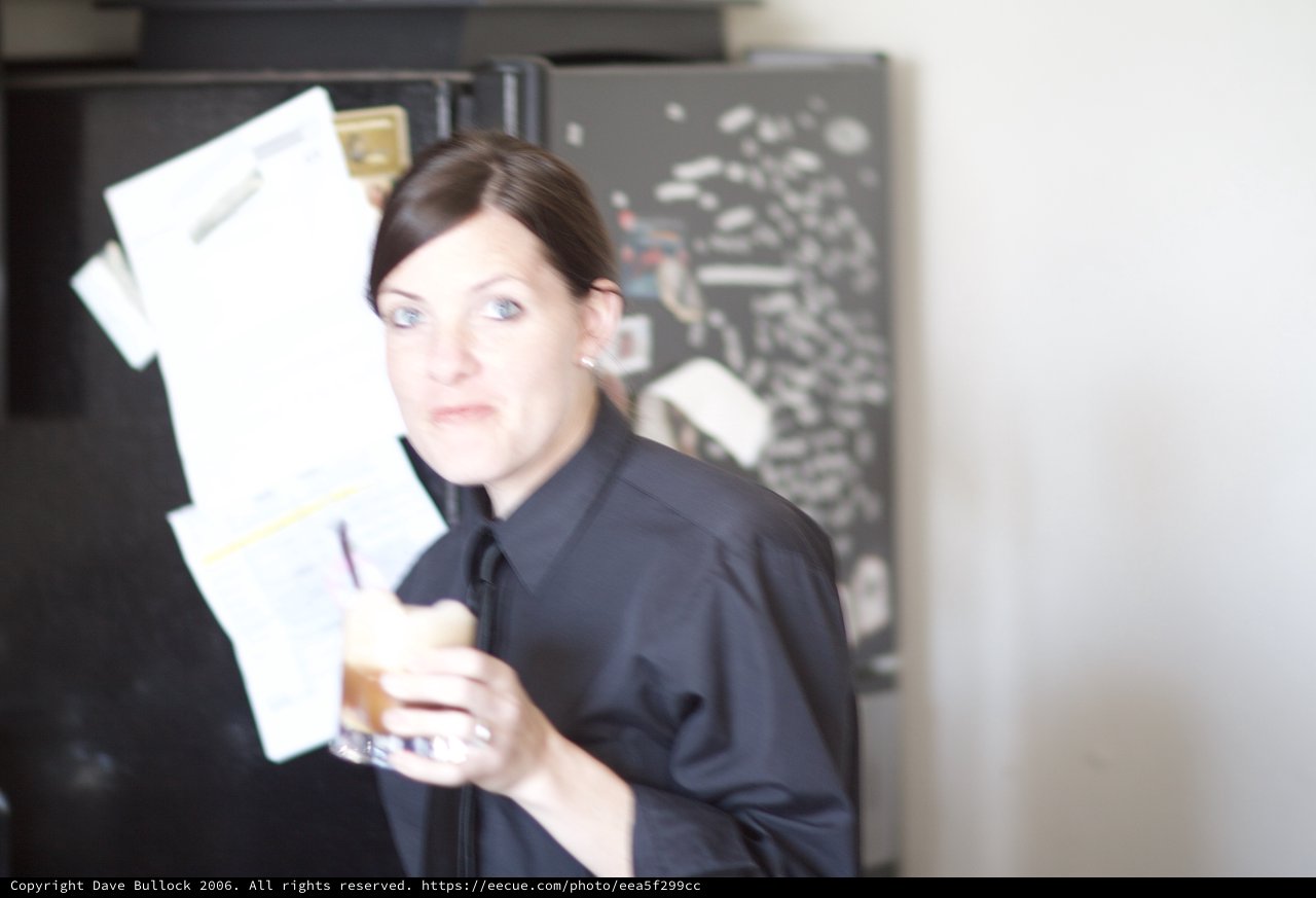 Woman Reviews Bills with Concerned Expression in Kitchen
