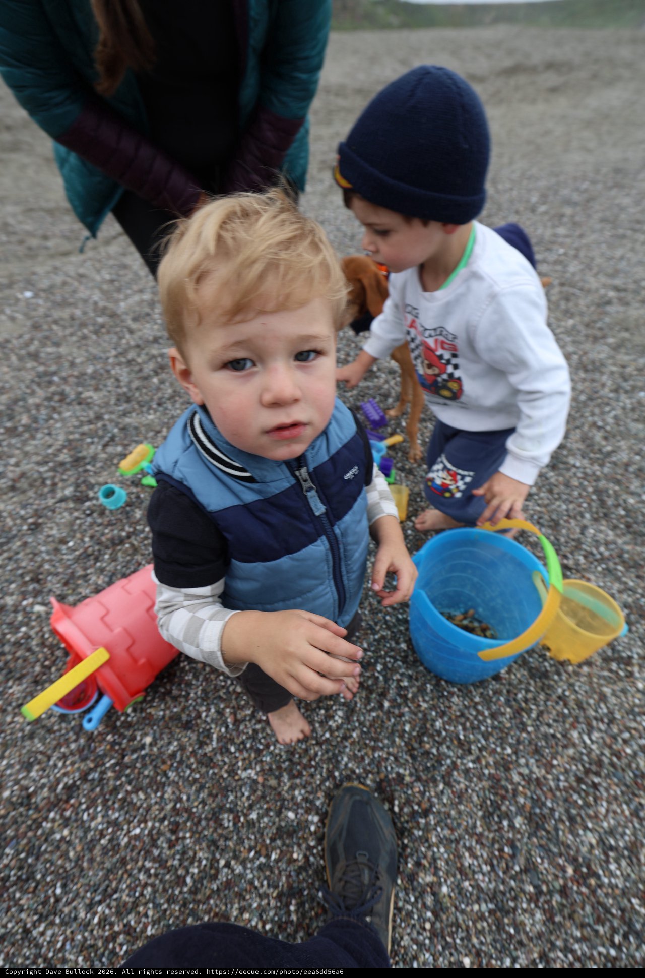 Two Young Boys Playing on a Pebble Beach