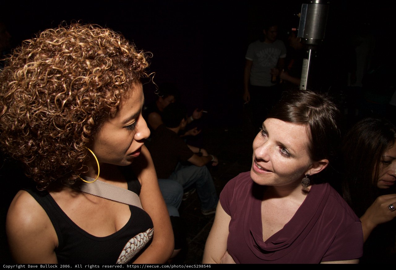 Two Women Sharing a Moment at a Nightclub