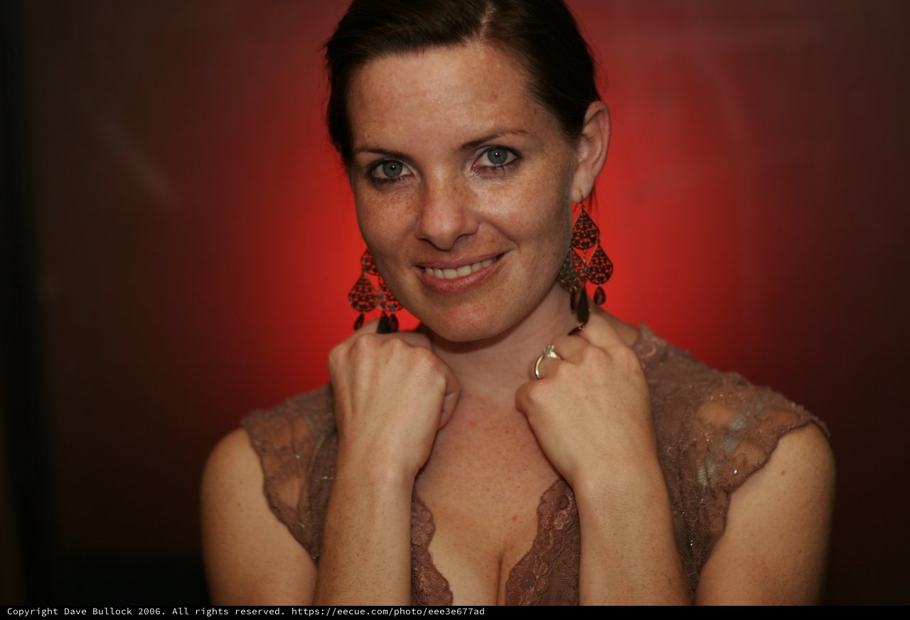 Confident Woman Poses Against Dramatic Red Background