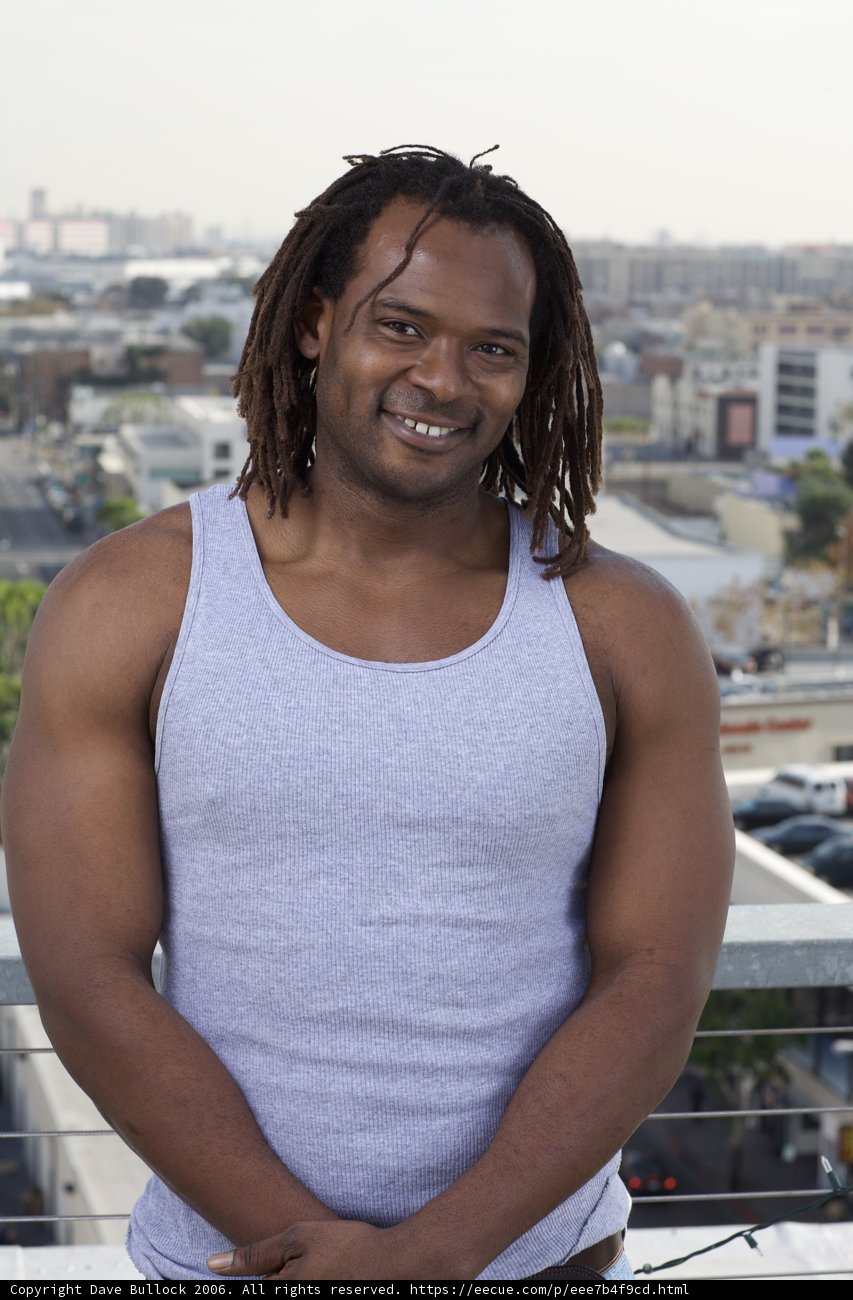 Smiling Man with Dreadlocks in the City