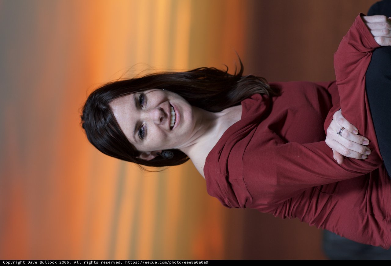 Woman Smiling Against a Vivid Sunset Sky