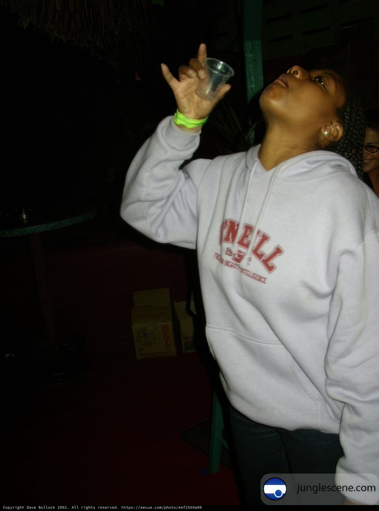 Hoodie Woman Drinking from a Bottle
