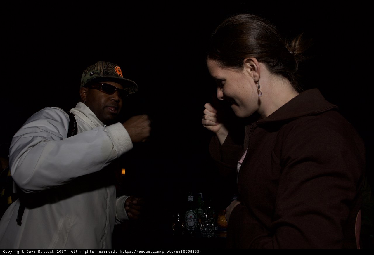 Playful Boxing Pose Between Two Friends at Night