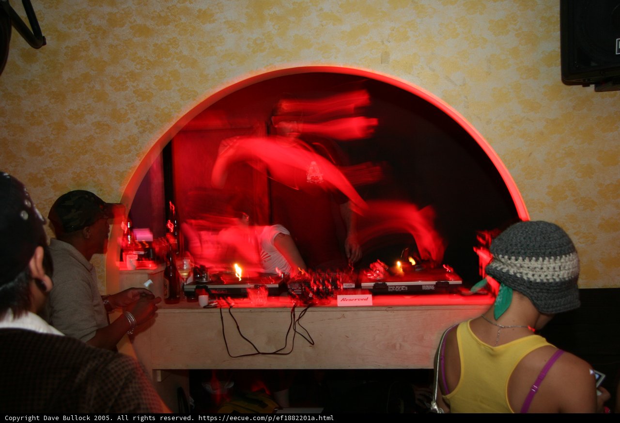 Hat-wearing couple with DJ