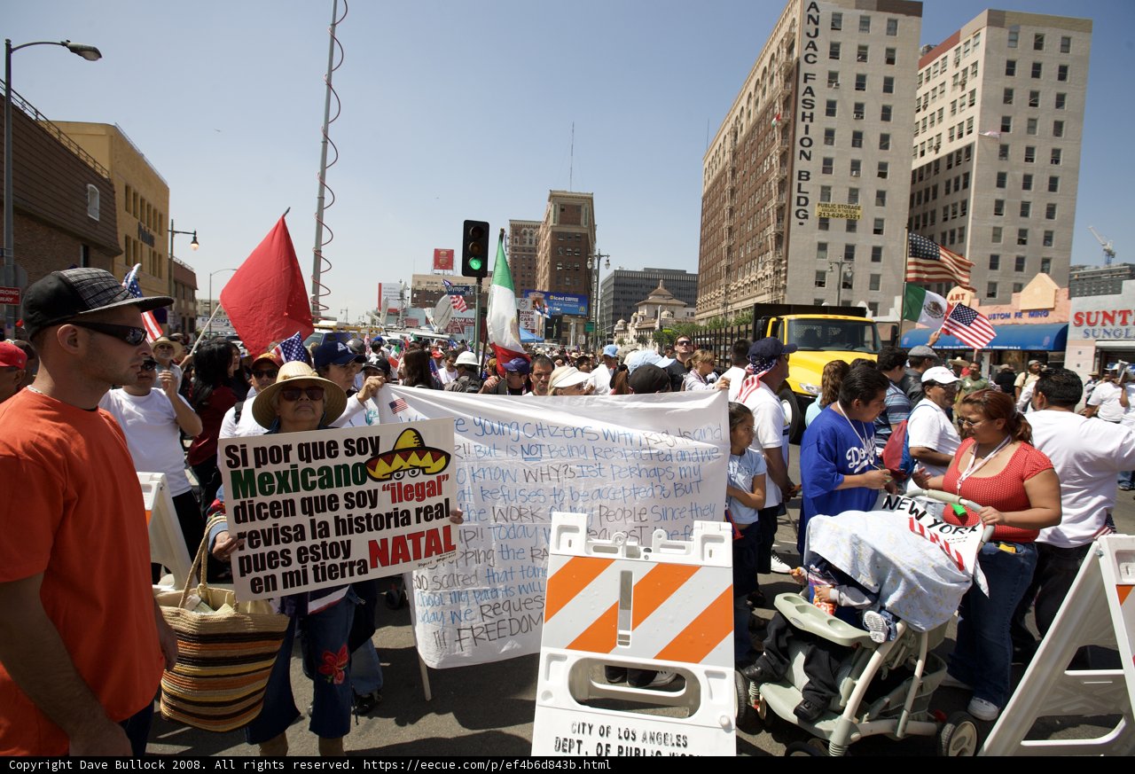Mayday Rally Marchers Wave Banner in the Blue Sky