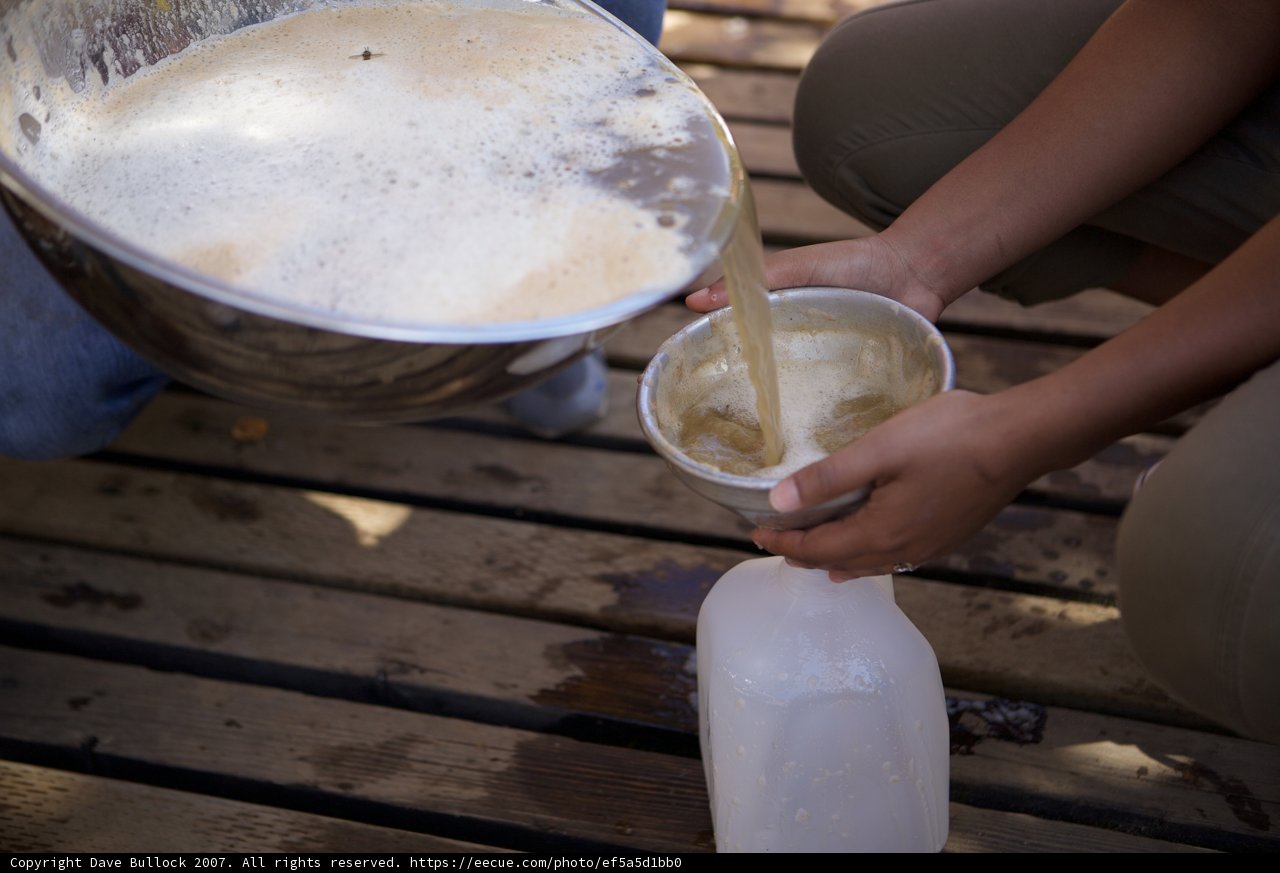 Pouring Milk into a Wooden Cup