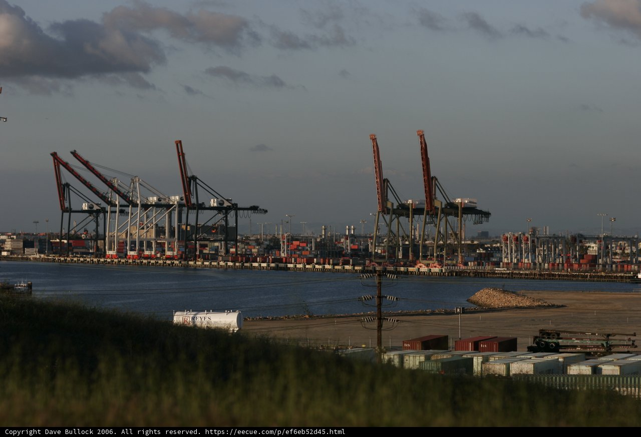 Bustling Harbor with Industrial Cranes and Ships