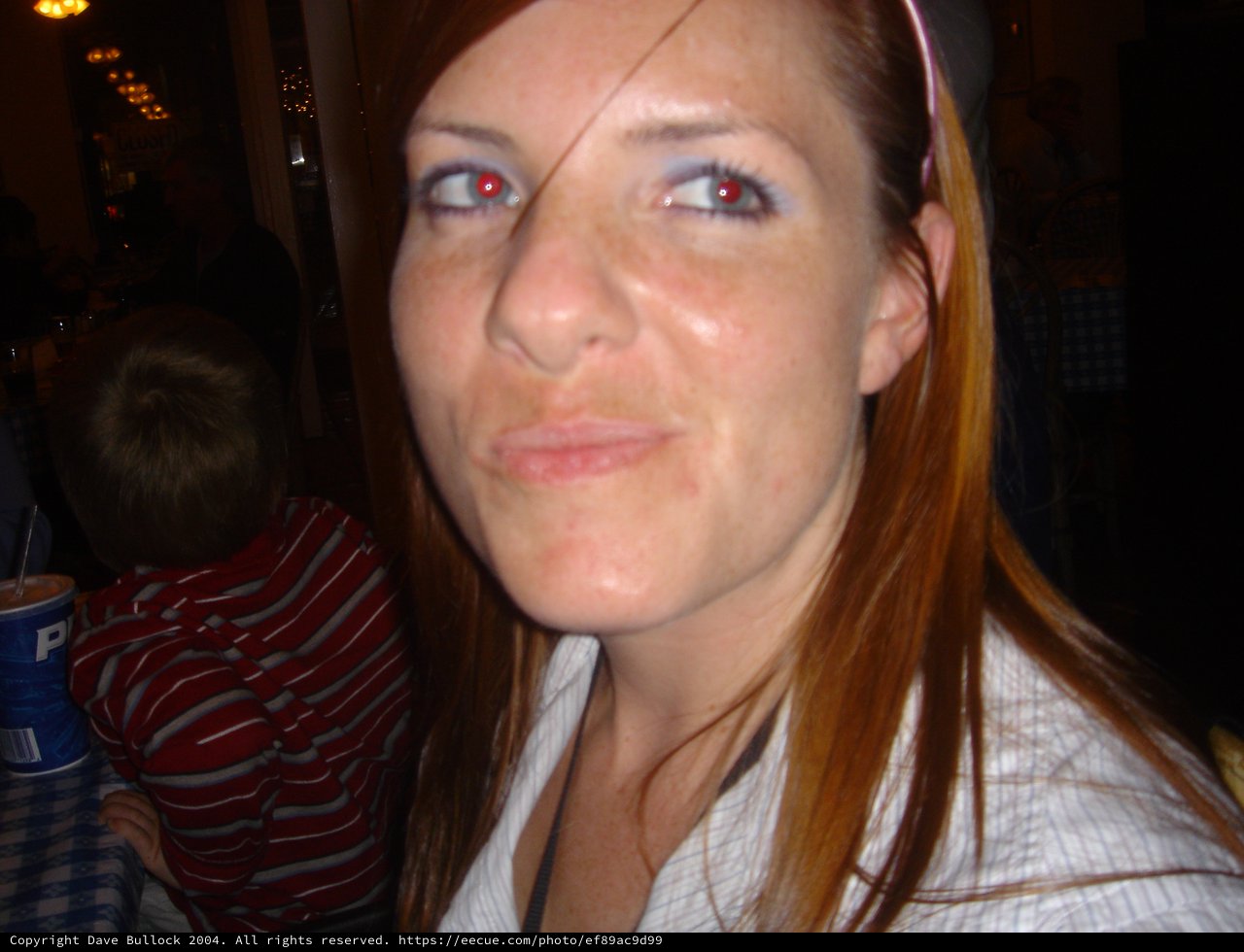Red-Haired Woman with Red-Eye Effect at Restaurant