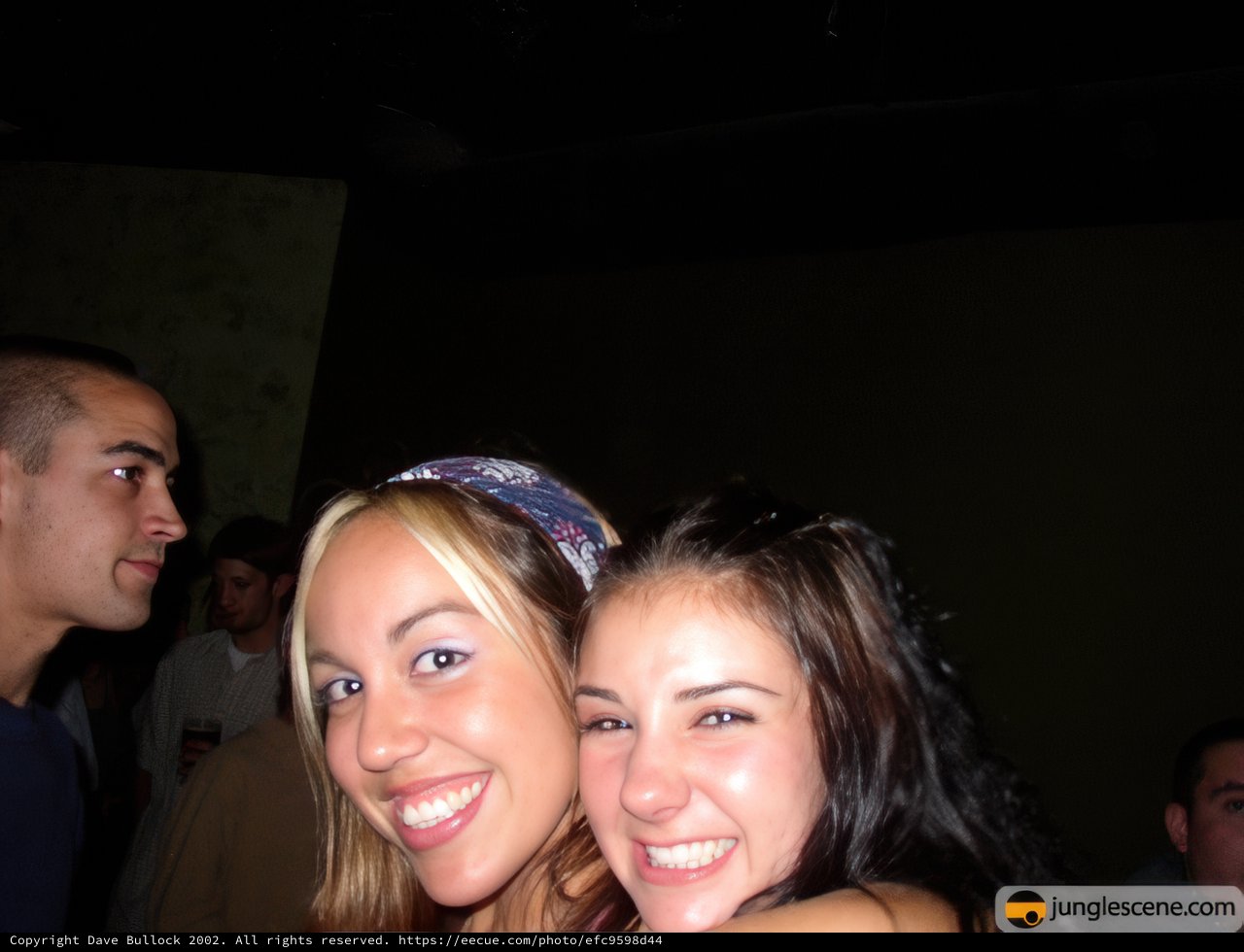 Two Smiling Women at a Night Club