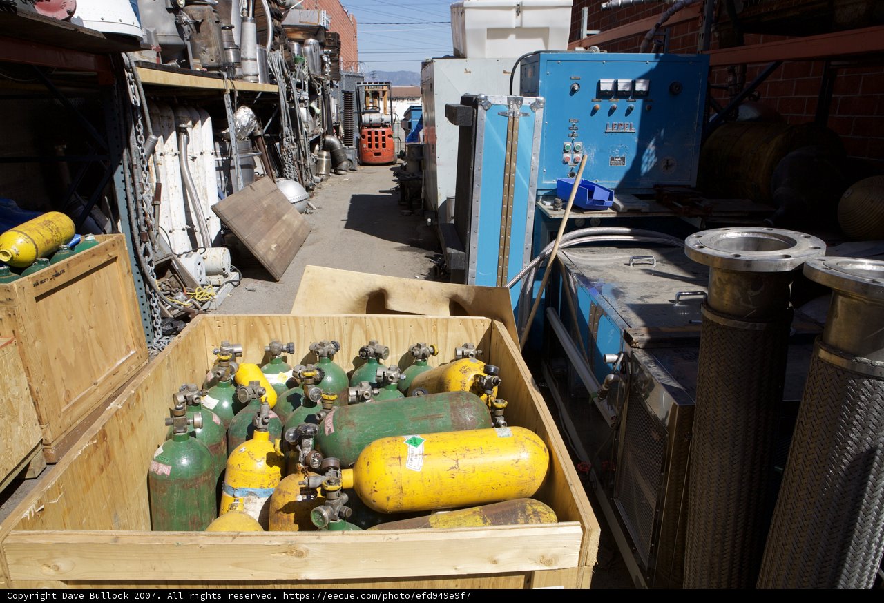 Colorful Gas Tanks in Wooden Crate