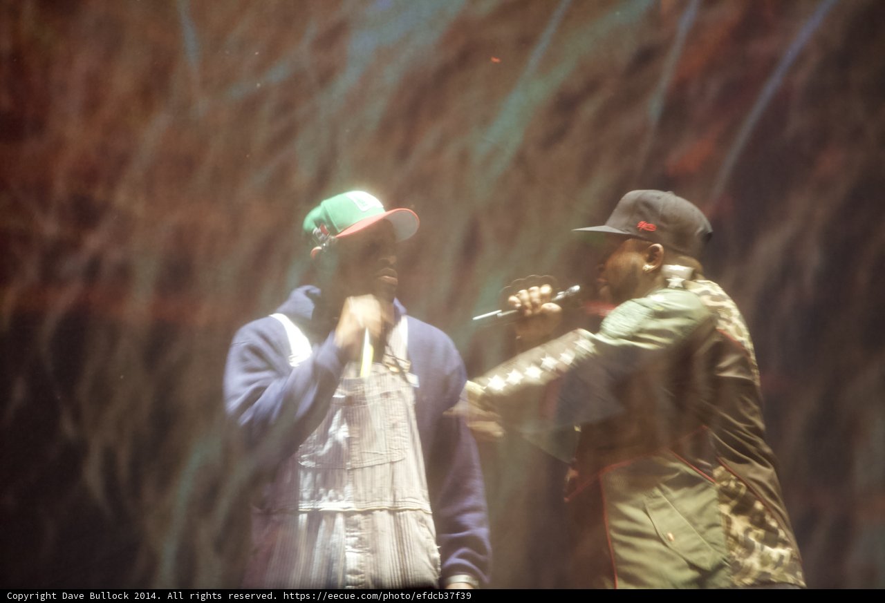 Two Men in Hats Rockin' the Stage Caption: Two talented men in stylish hats bring down the house with their electrifying vocals at Coachella 2014.