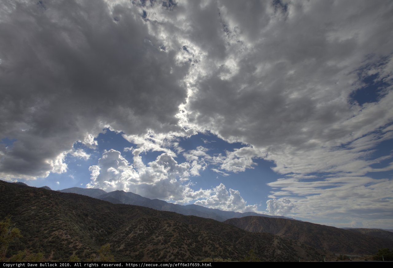 Majestic mountain range and cumulus clouds
