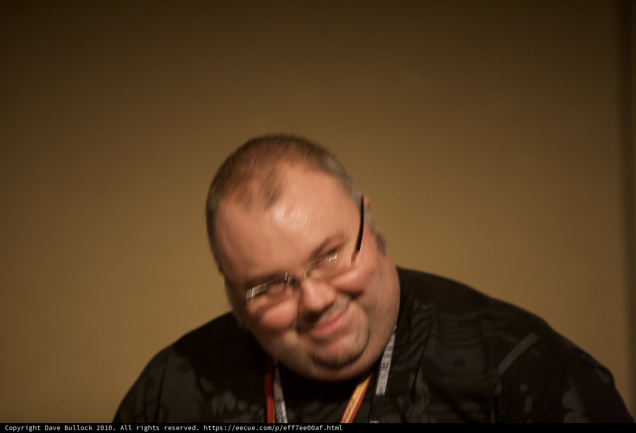 Smiling Man in Black Shirt and Glasses
