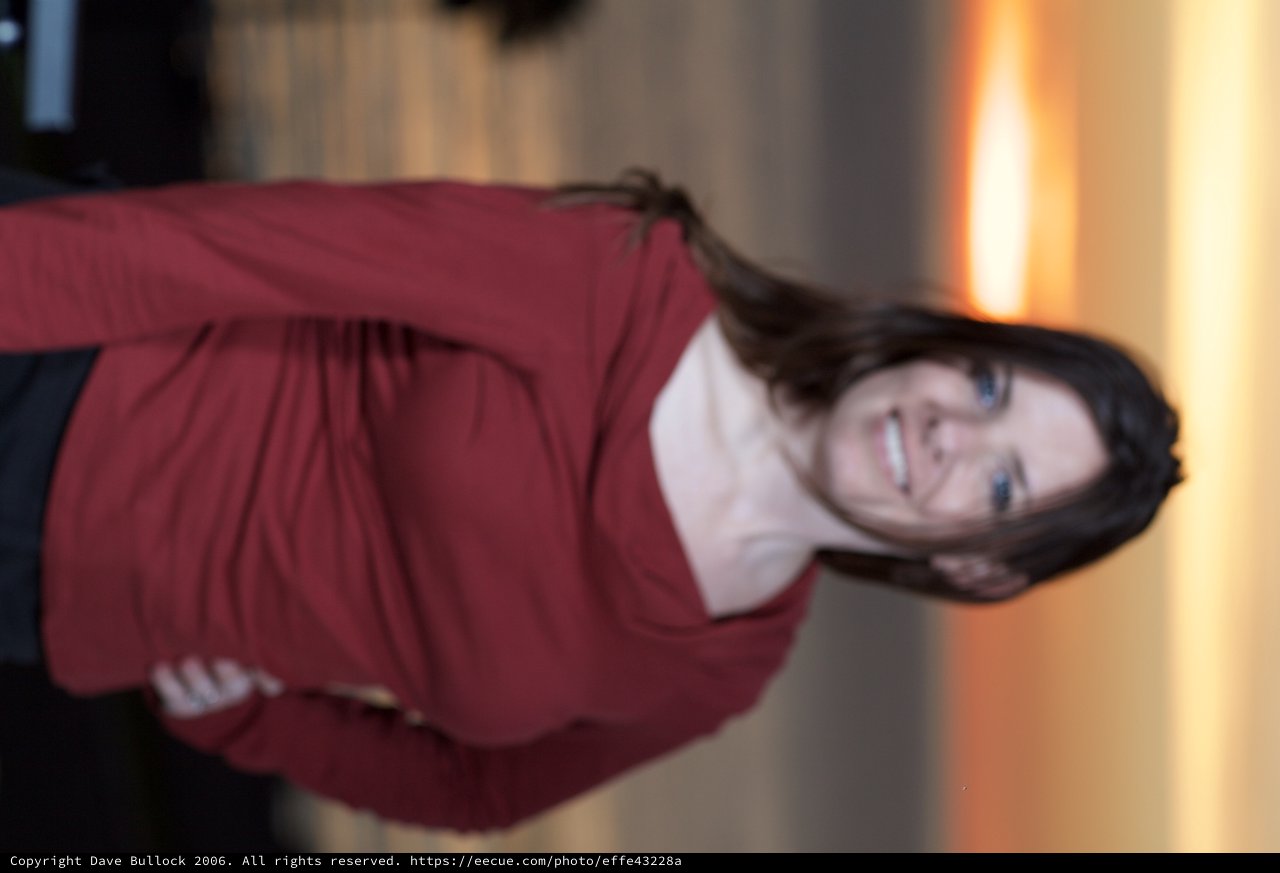 Woman Smiling at Sunset Over Open Water