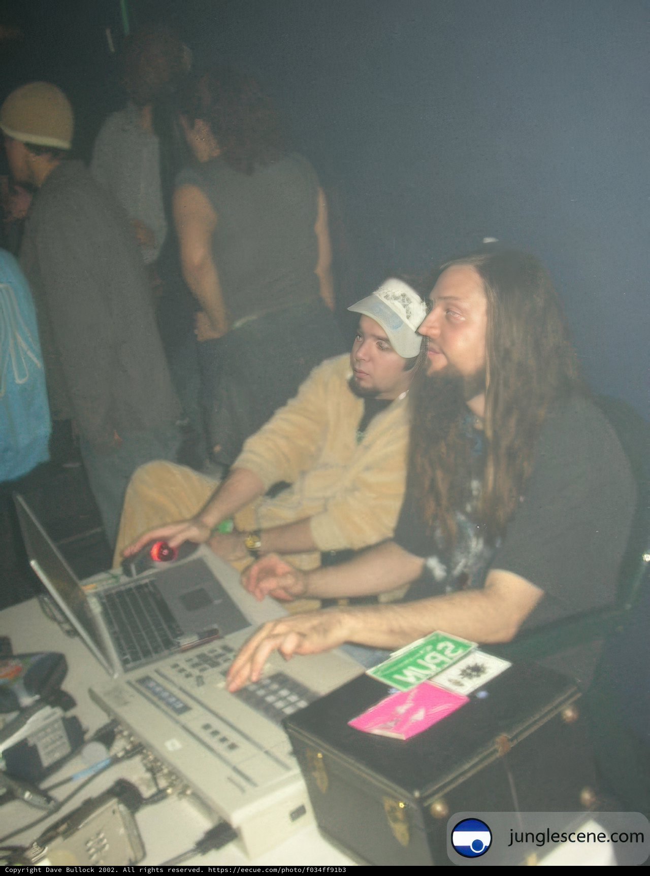 Long-Haired Man Working on Laptop at the Club