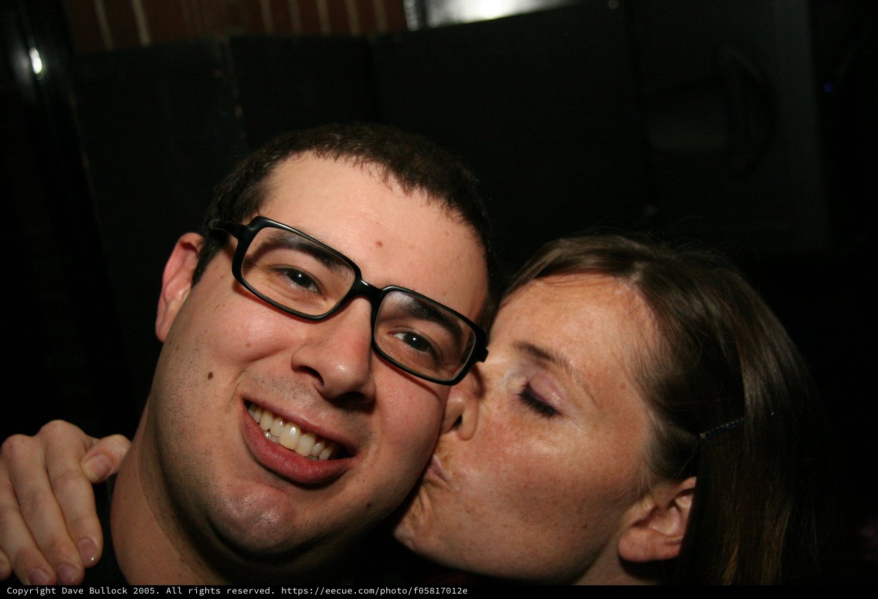 Spontaneous Kiss on the Cheek at Night Event