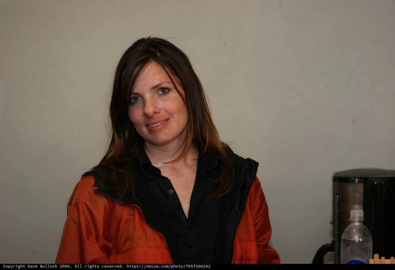 Woman in Orange Jacket Smiling Indoors 2006