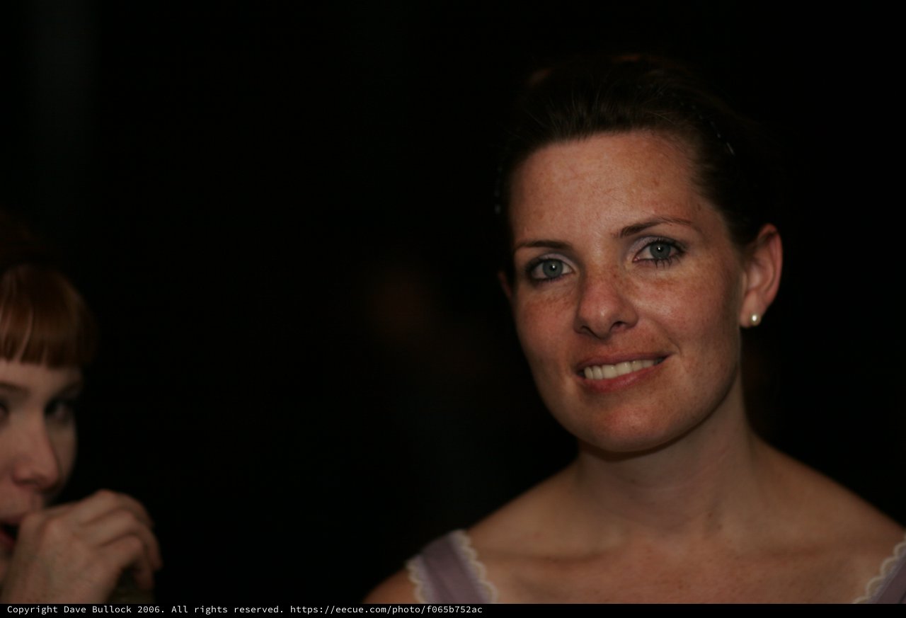 Smiling Woman with Freckles at Evening Event
