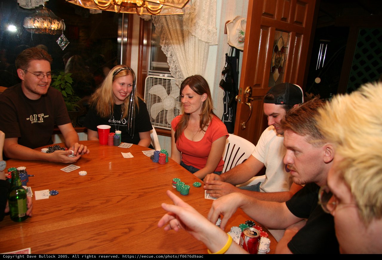 Friends Gathered Around Table for Poker Night