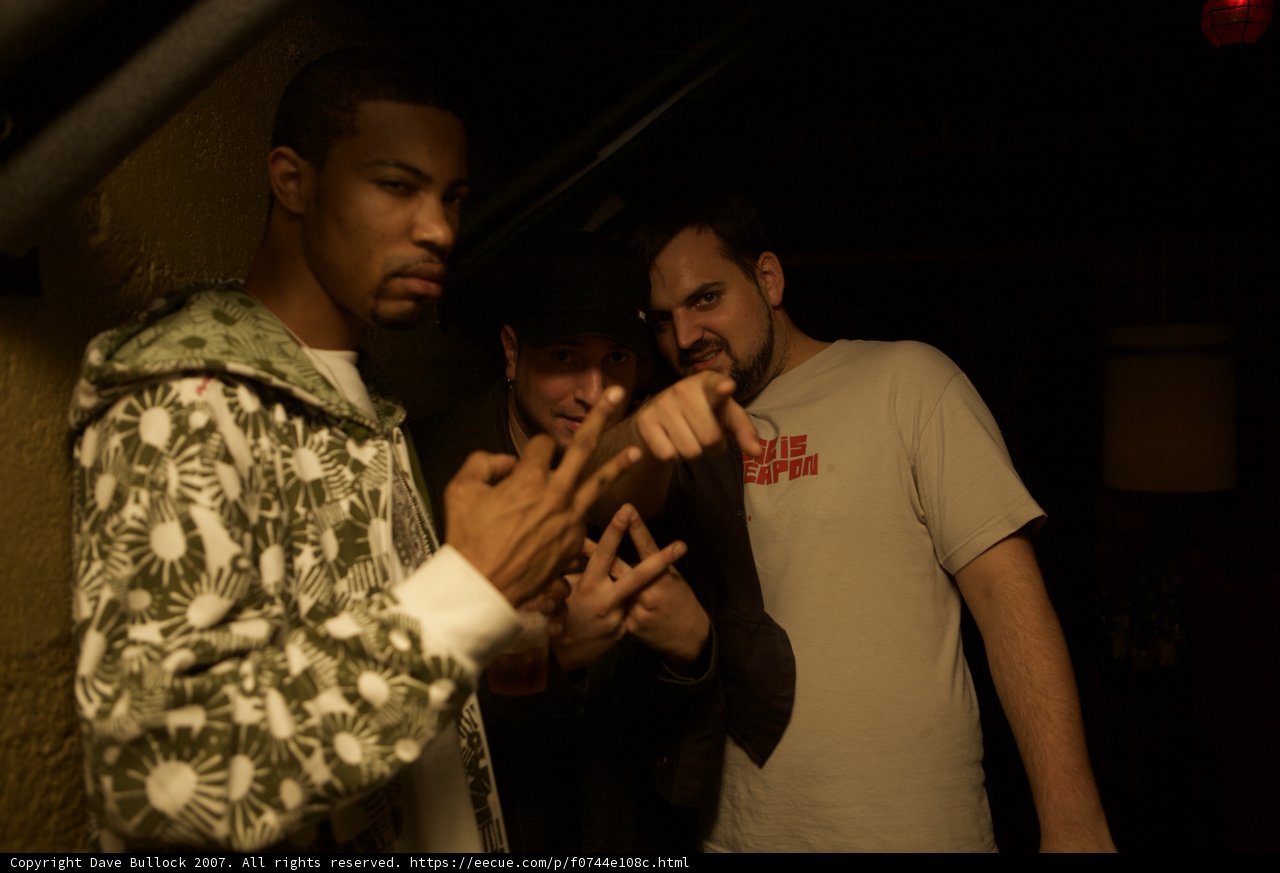Three Entertainers in a Dimly Lit Club