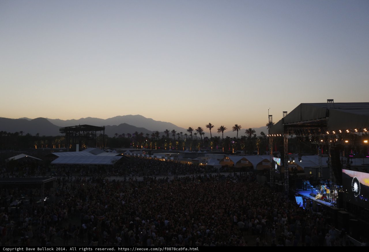 Concertgoers Rock Out Against Majestic Mountain Backdrop