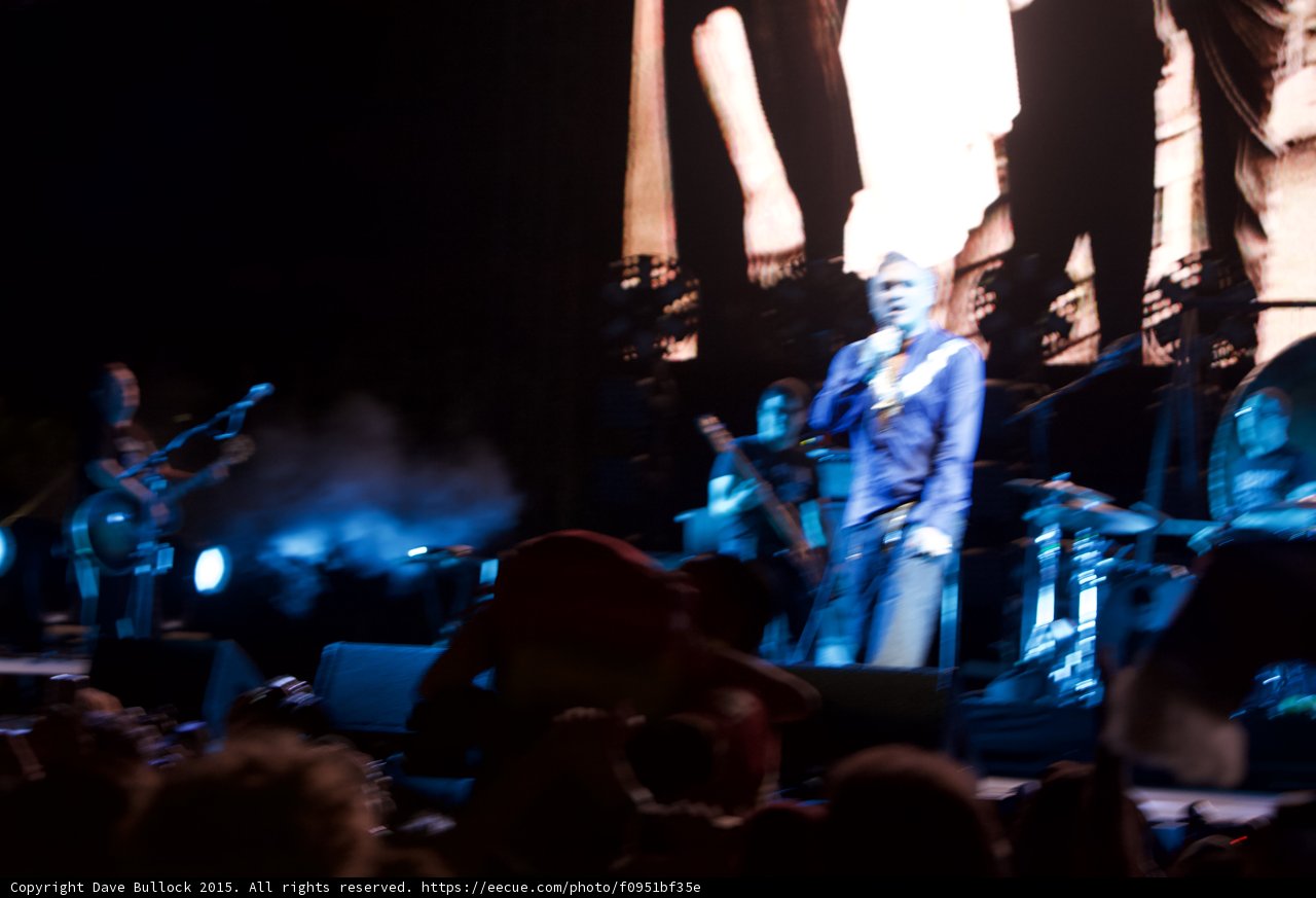 Morrissey Wide Stage Motion Blur Blue Shirt Bassist Guitarist Smoke Haze LED Panels Smiths Screen Crowd