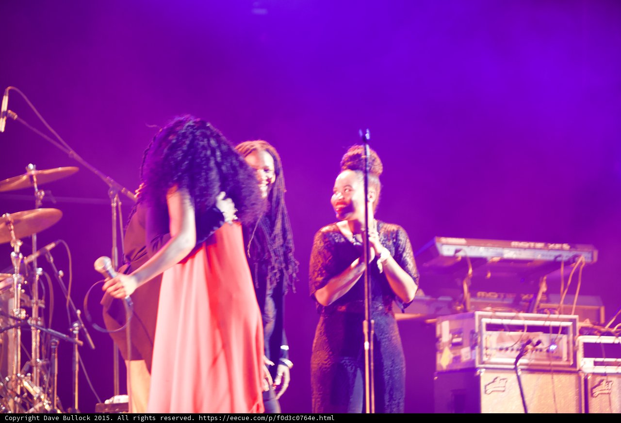 Solange Hugging Backing Vocalist Dreadlocks Red Dress Black Lace Vocalist Smiling